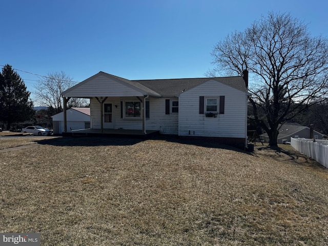 view of front of home featuring a front yard, fence, and a chimney