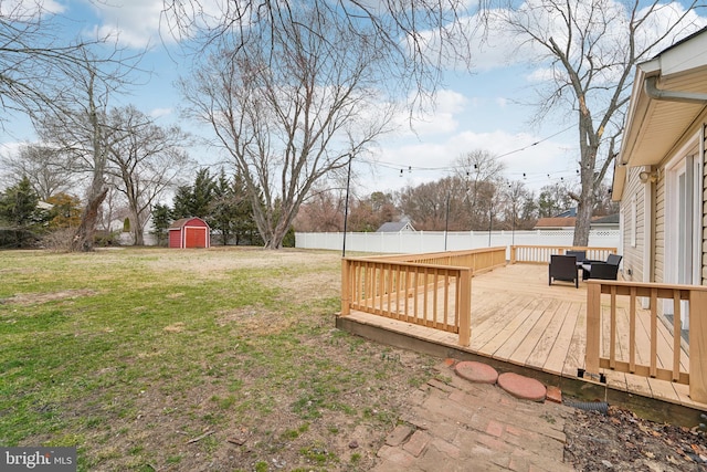 1110 Bradley Rd, Pasadena, MD 21122 - view of yard with a deck, an outdoor structure, a fenced backyard, and a shed