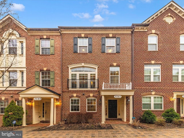 townhome / multi-family property with brick siding