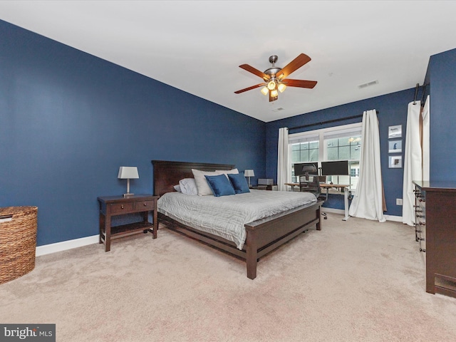 carpeted bedroom featuring lofted ceiling, visible vents, ceiling fan, and baseboards