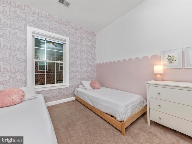 bedroom with baseboards, carpet flooring, visible vents, and wallpapered walls