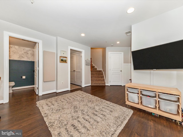 unfurnished living room featuring recessed lighting, visible vents, baseboards, stairs, and dark wood-style floors