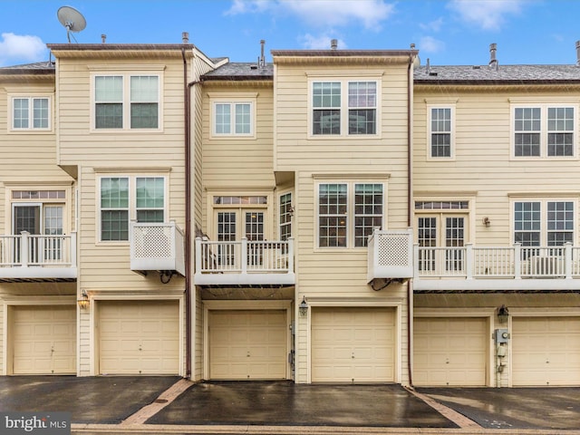 rear view of property with a garage and driveway