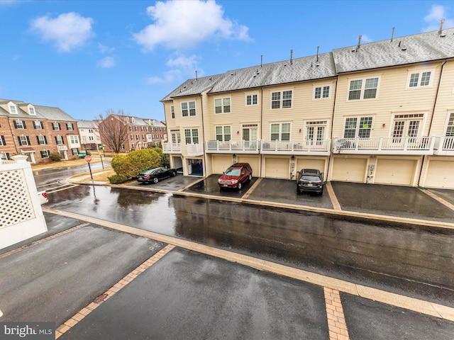 view of car parking featuring a residential view