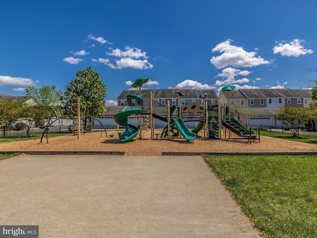 community playground featuring a residential view and fence