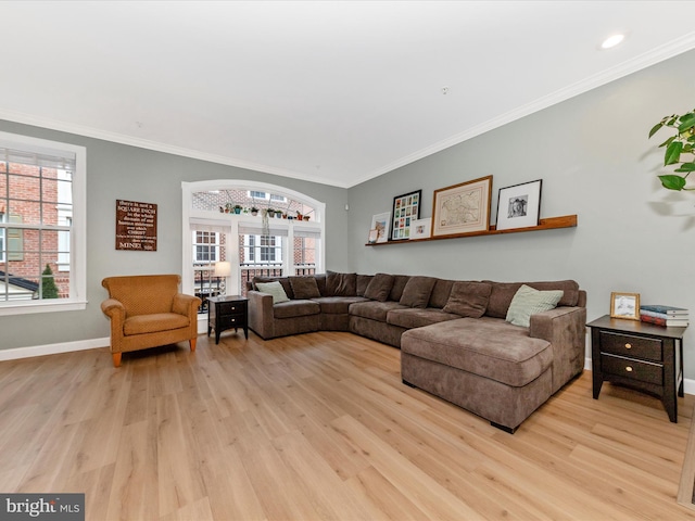 living room with light wood-type flooring, crown molding, baseboards, and recessed lighting