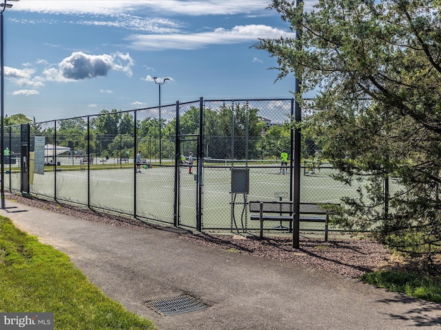 view of sport court featuring a gate and fence