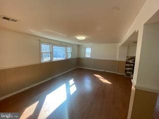 interior space featuring visible vents, baseboards, and wood finished floors