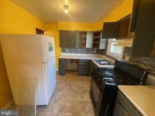 kitchen with dark brown cabinetry, freestanding refrigerator, decorative backsplash, open shelves, and gas stove