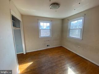 unfurnished bedroom featuring baseboards and wood finished floors