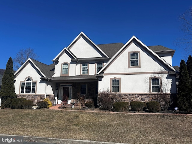 view of front of property featuring stone siding and stucco siding