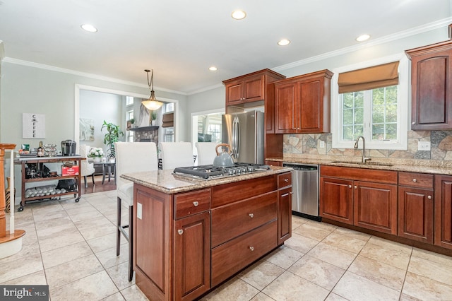 kitchen with a sink, backsplash, a center island, appliances with stainless steel finishes, and crown molding