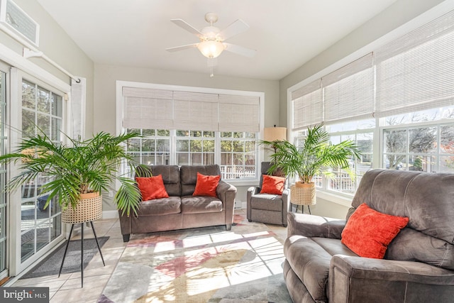 sunroom / solarium featuring a ceiling fan