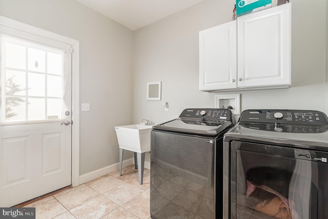 laundry area with light tile patterned floors, cabinet space, independent washer and dryer, and baseboards