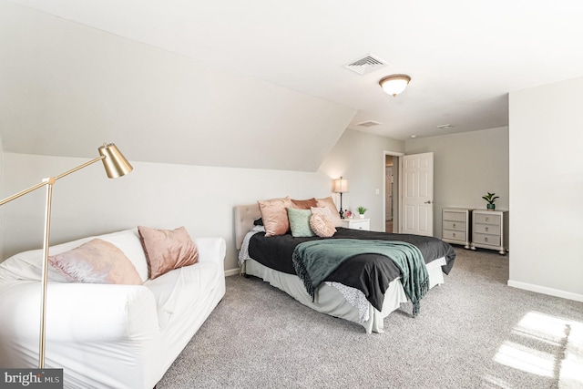 carpeted bedroom featuring lofted ceiling, baseboards, and visible vents