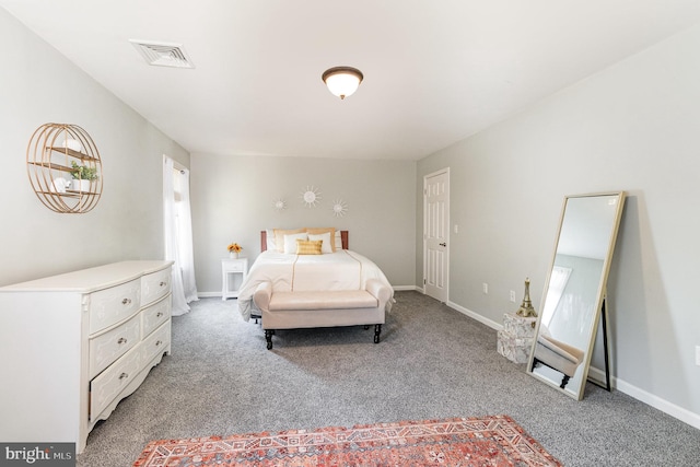 bedroom featuring visible vents, light colored carpet, and baseboards