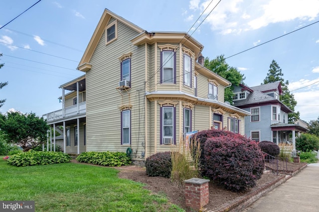 view of side of home featuring a yard and cooling unit