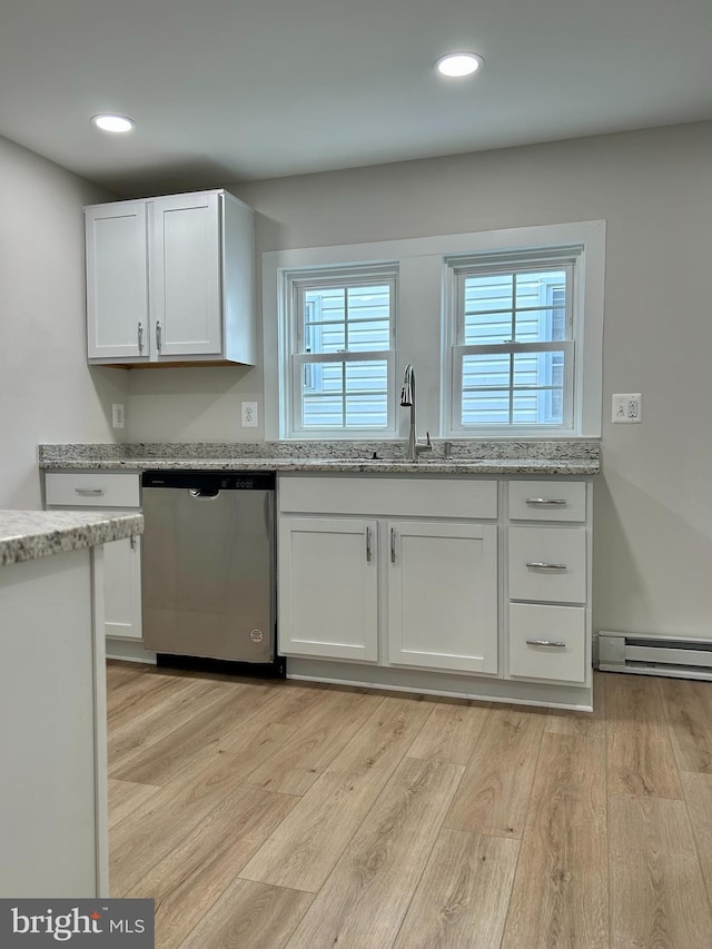 kitchen featuring light wood finished floors, white cabinetry, baseboard heating, and stainless steel dishwasher