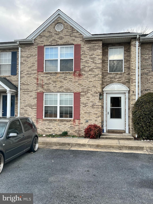 townhome / multi-family property featuring brick siding