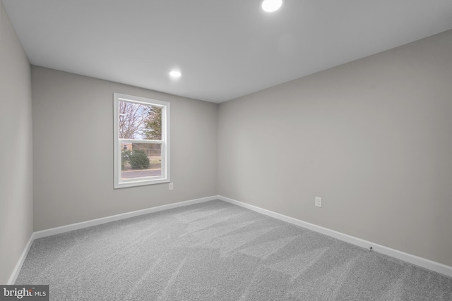 carpeted spare room with recessed lighting and baseboards