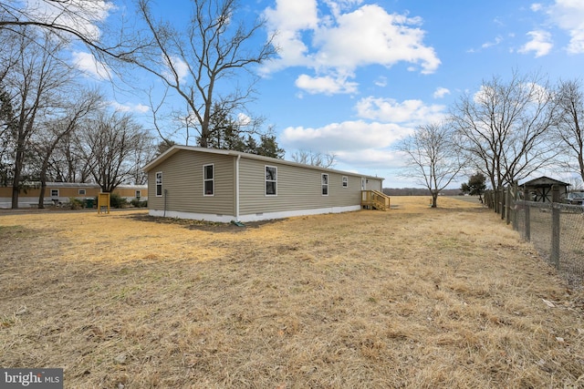 view of home's exterior featuring crawl space and fence