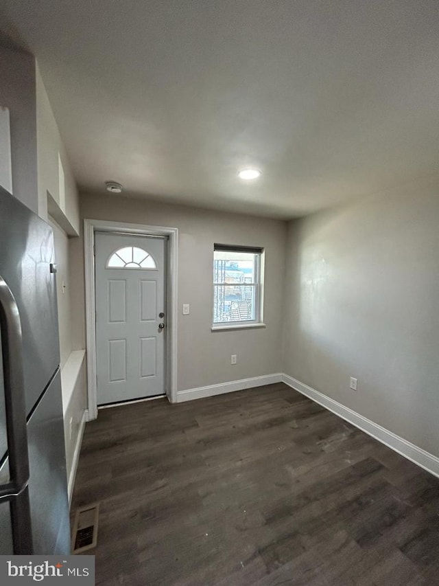 entrance foyer featuring visible vents, dark wood-style floors, and baseboards