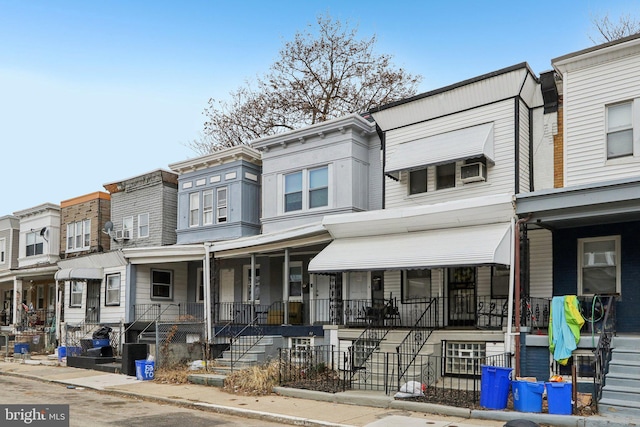 multi unit property with covered porch and a residential view