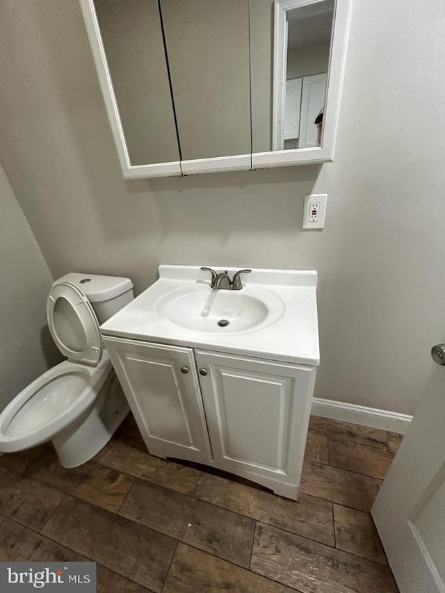 half bath featuring toilet and vanity