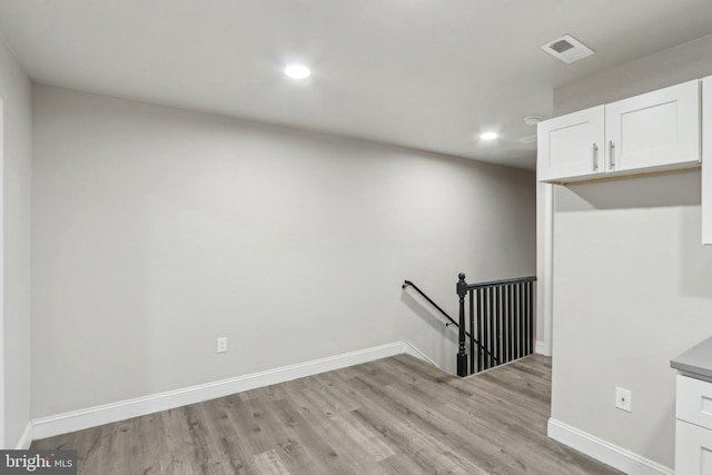 stairway with visible vents, recessed lighting, baseboards, and wood finished floors