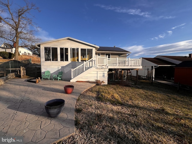 exterior space featuring a patio area, stairway, fence, and a deck