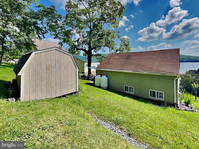 exterior space with an outdoor structure, a yard, and a shed