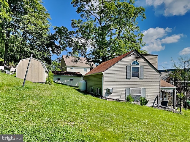 view of property exterior with an outdoor structure and a yard