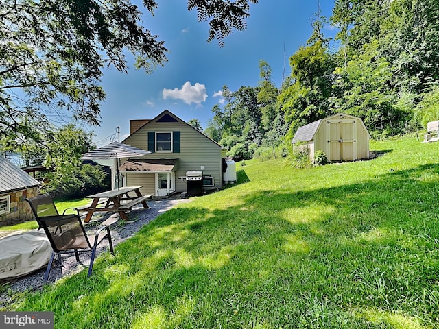 view of yard with an outdoor structure, a shed, and a patio