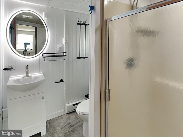 bathroom featuring vanity, a baseboard radiator, a stall shower, toilet, and marble finish floor