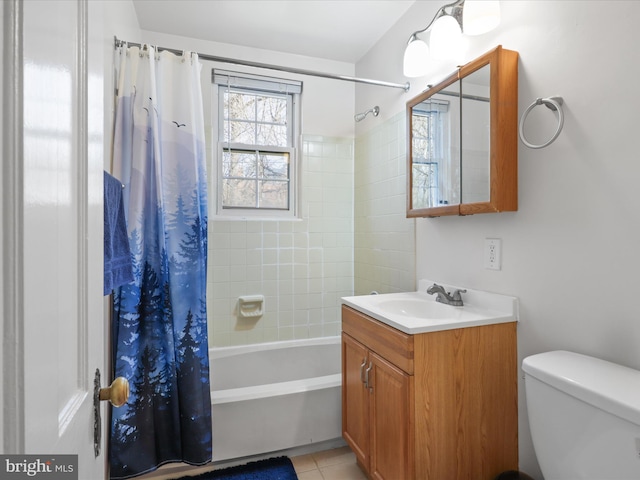 full bathroom featuring tile patterned floors, shower / bath combo with shower curtain, toilet, and vanity