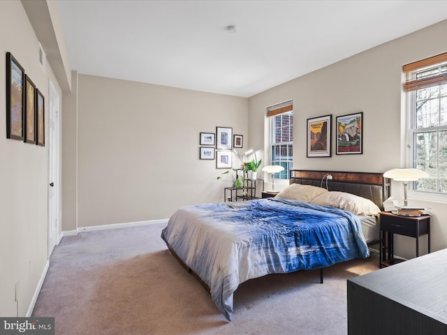 carpeted bedroom with visible vents and baseboards