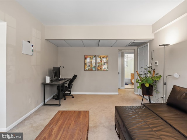 interior space with a paneled ceiling, baseboards, and light colored carpet