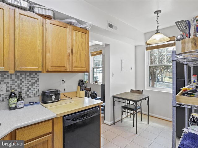 kitchen with visible vents, plenty of natural light, dishwasher, and decorative backsplash