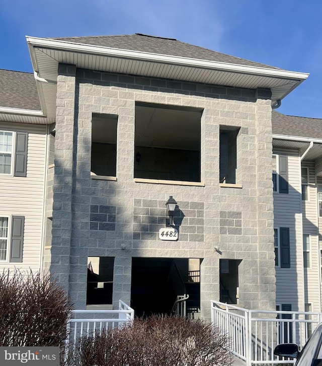 exterior space featuring a shingled roof