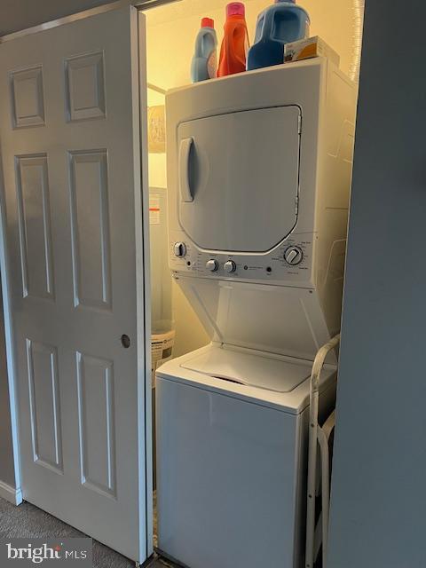 washroom with stacked washer and clothes dryer