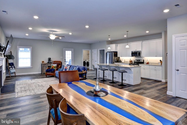 dining room featuring visible vents, recessed lighting, dark wood-type flooring, and baseboards