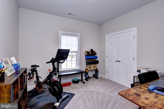 exercise area featuring visible vents, baseboards, and carpet floors