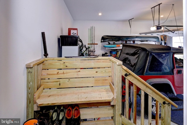 garage with recessed lighting and a garage door opener