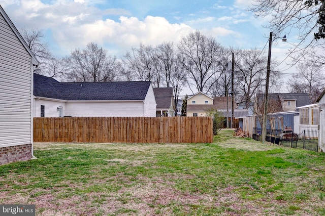 view of yard with fence and a residential view