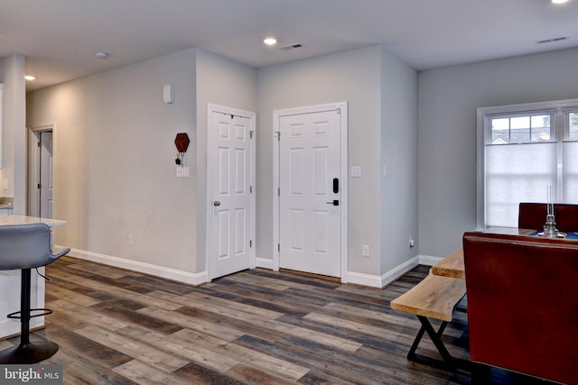 foyer with visible vents, recessed lighting, baseboards, and dark wood-style flooring