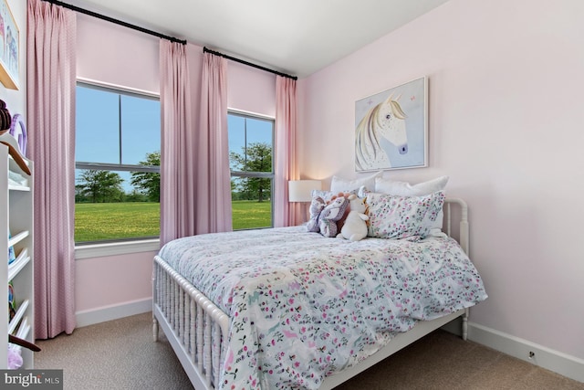 bedroom featuring carpet flooring and baseboards