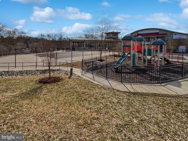 community play area featuring fence and a yard