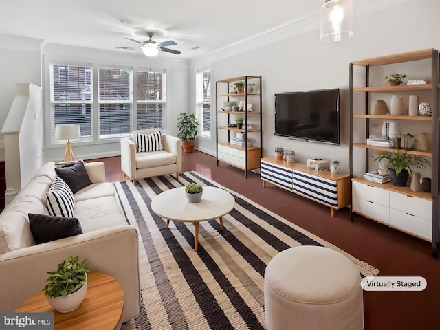 living area with ornamental molding and a ceiling fan