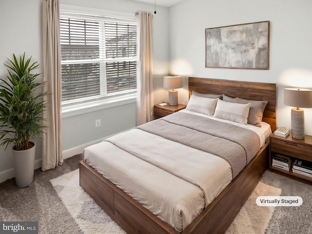 carpeted bedroom with baseboards