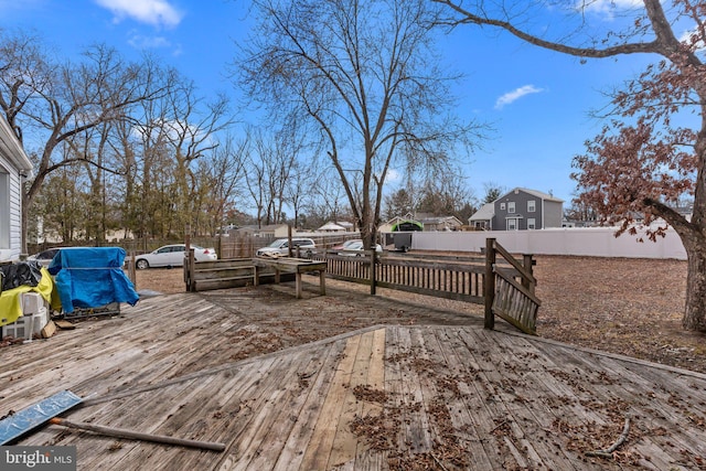 wooden terrace featuring a fenced backyard